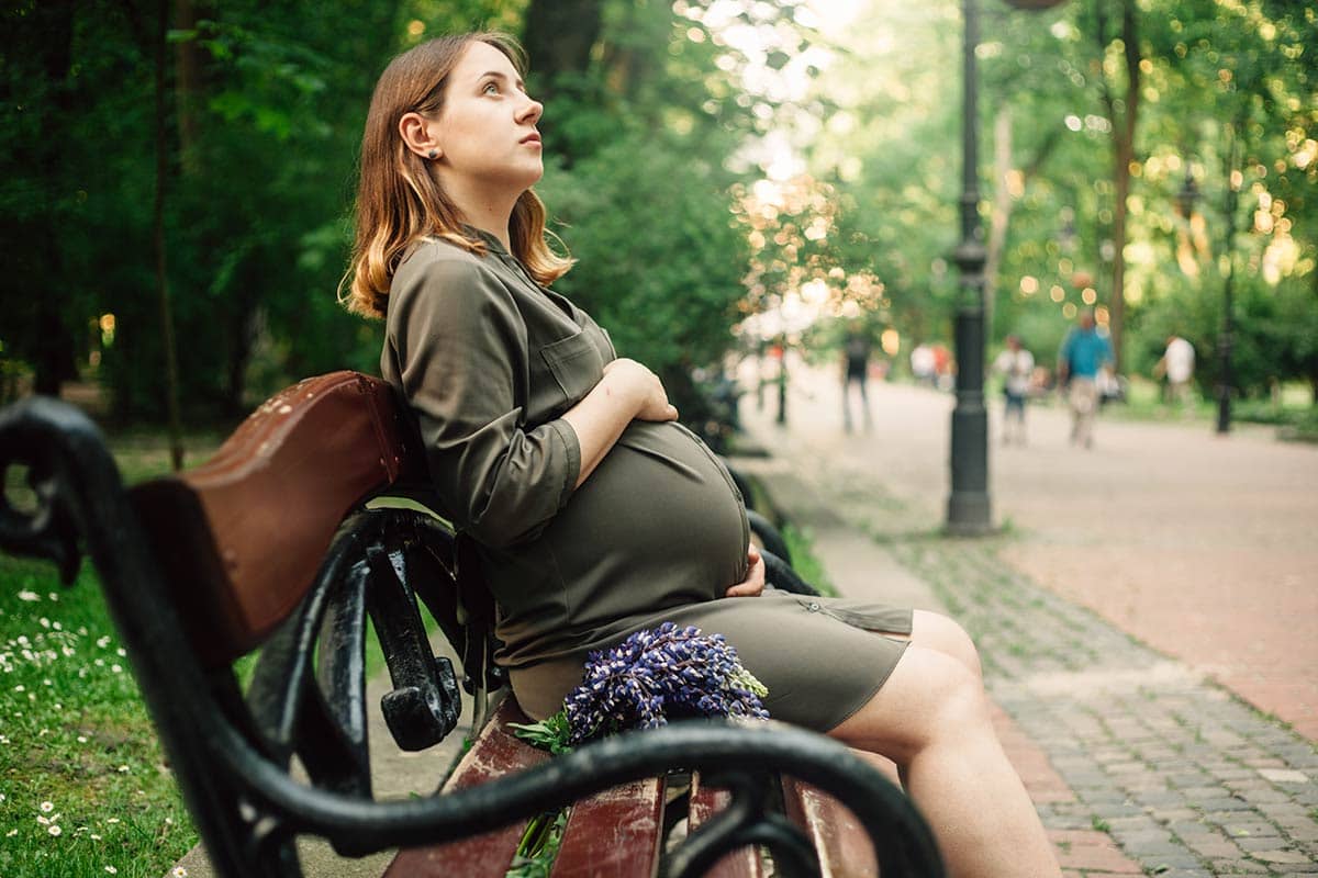 pregnant woman sitting outdoors