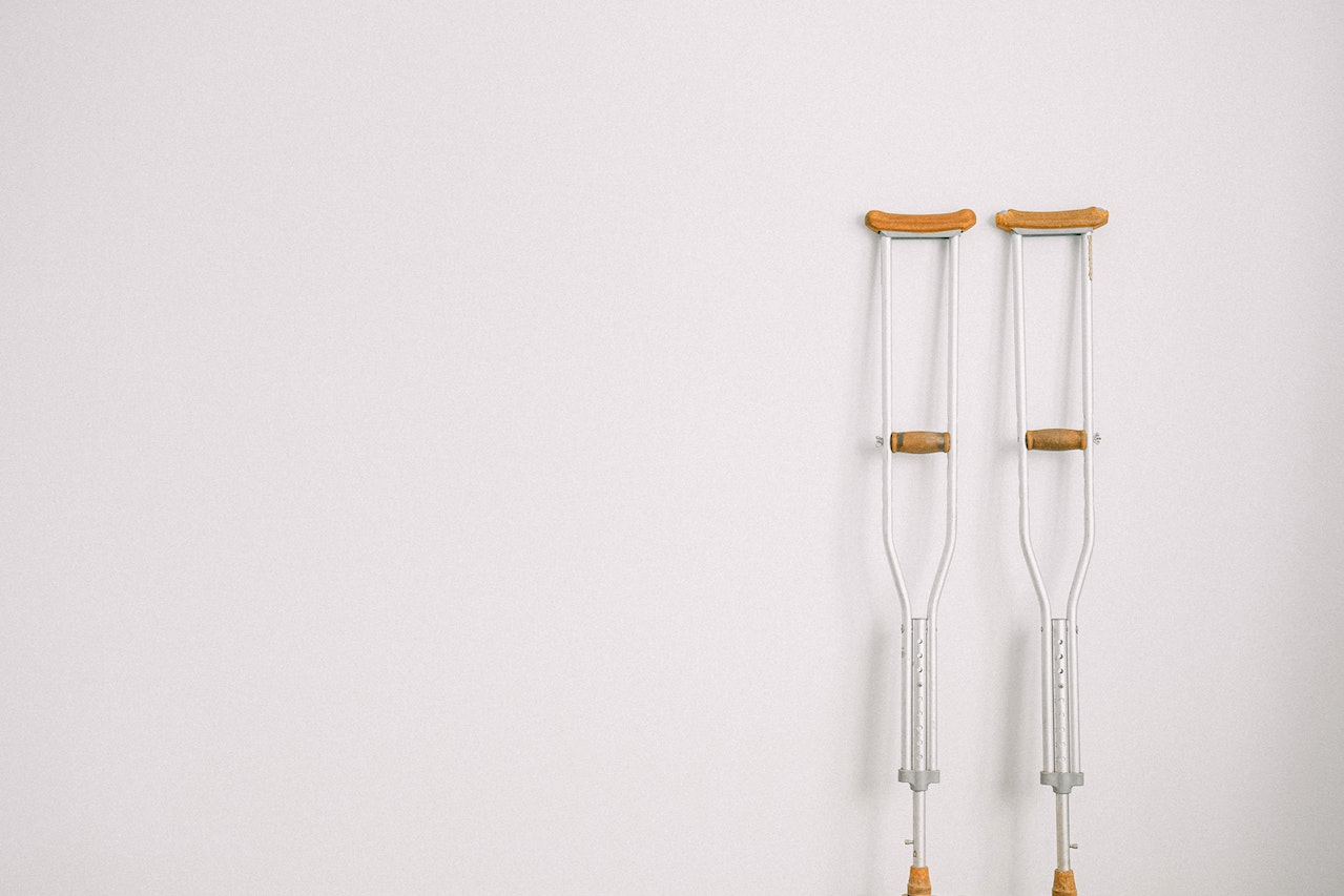 A pair of crutches resting against a wall