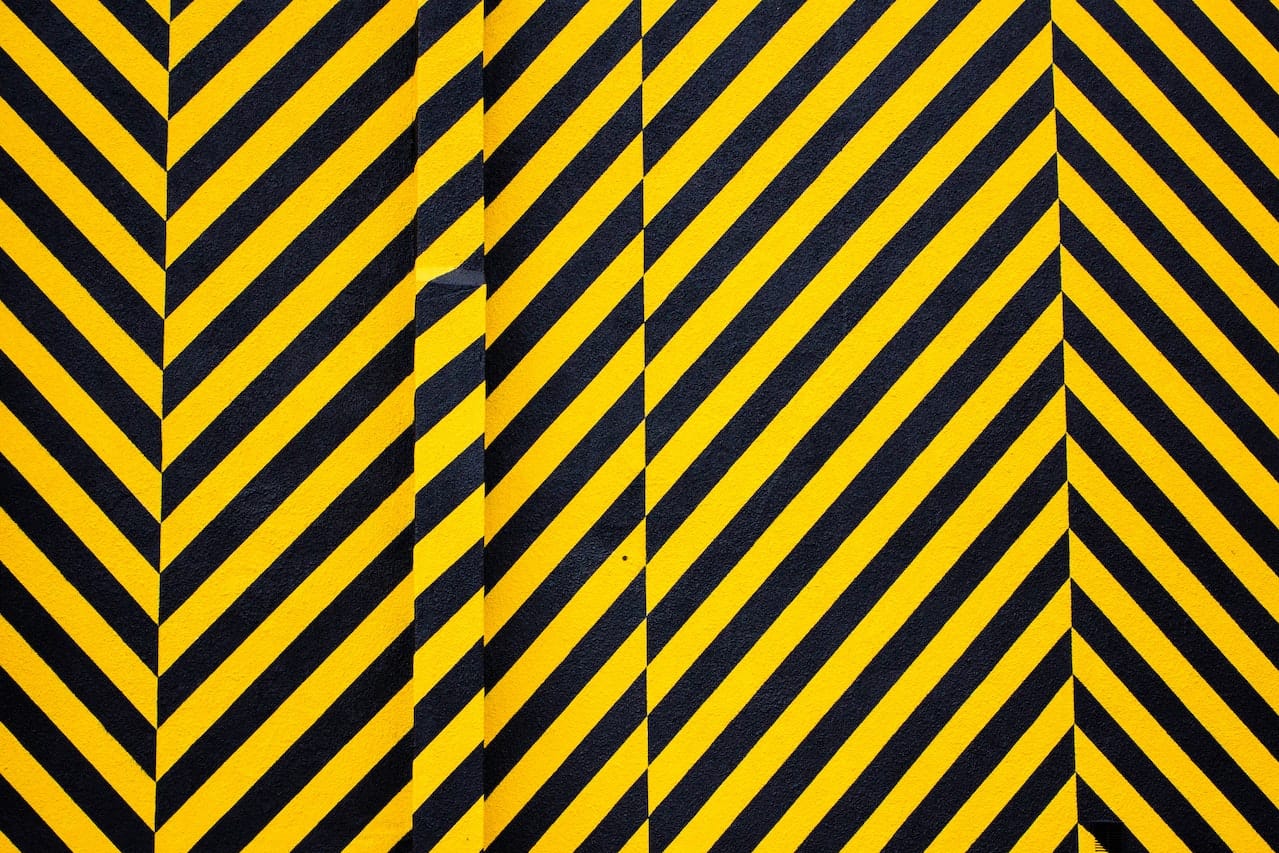 Yellow and black stripes on a wall signalling hazards