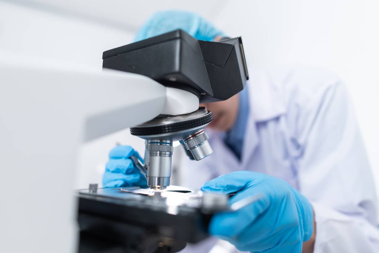 a doctor looking through a microscope