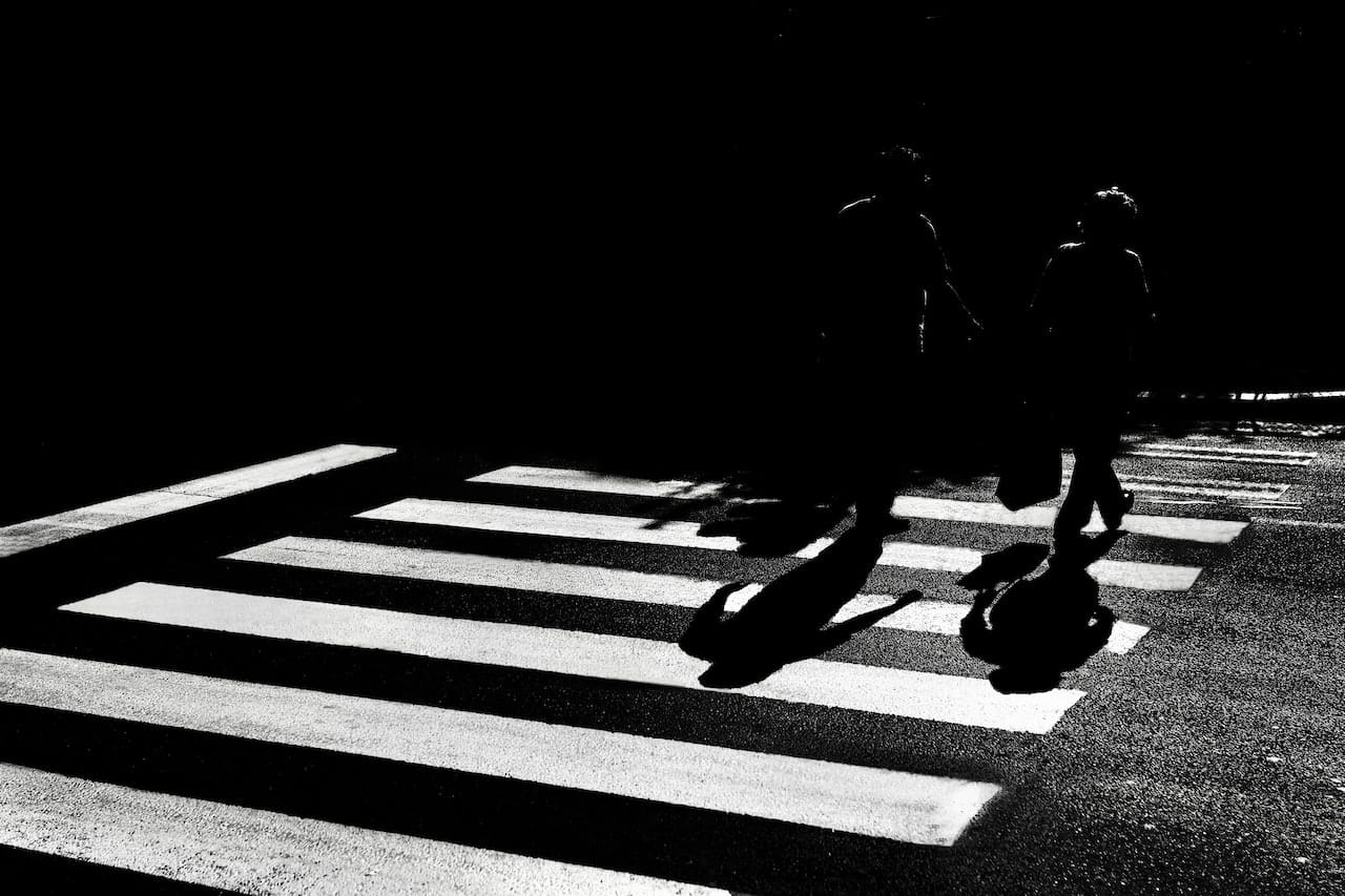 two people using a pedestrian crossing