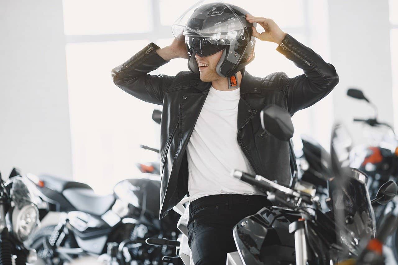 Someone trying on a motorbike helmet