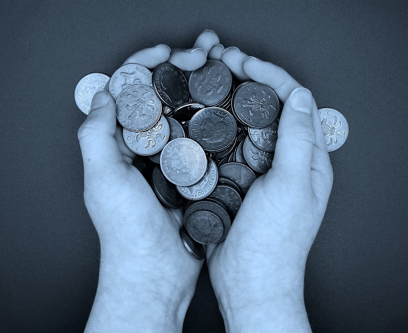 Someone holding a number of 2p coins in both hands