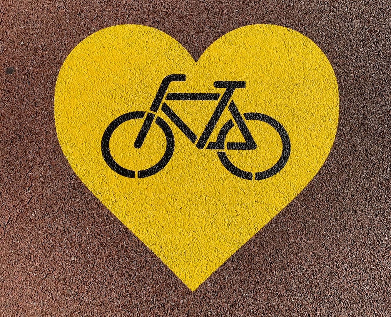 a bicycle in a yellow hear spray painted on a road