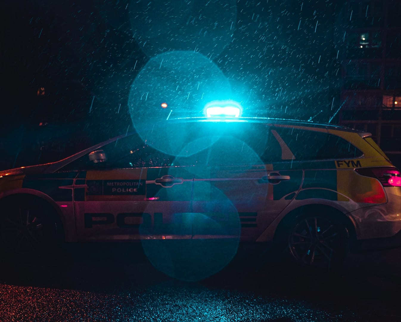 A police car lit up at night
