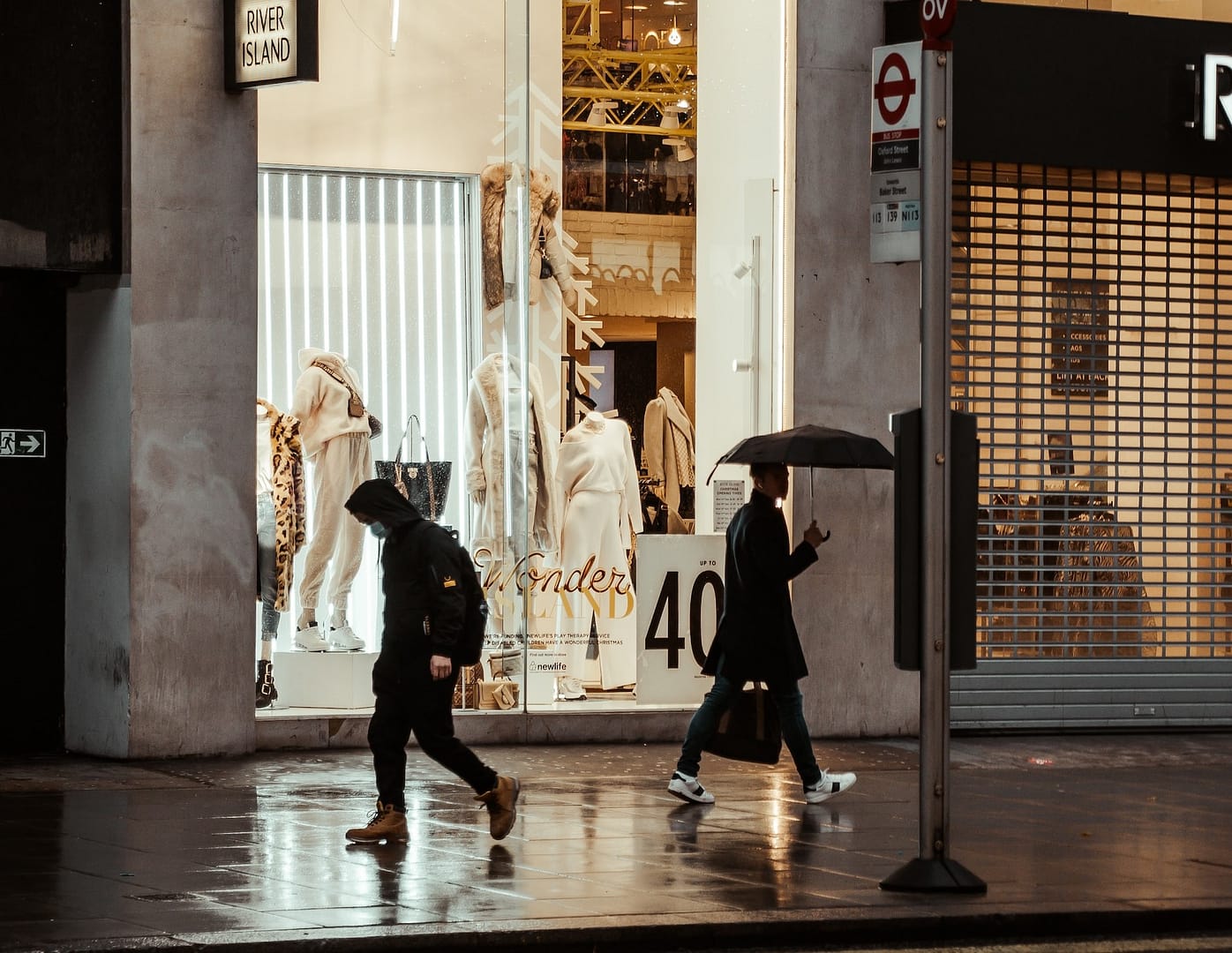 Two people walking on a rainy path