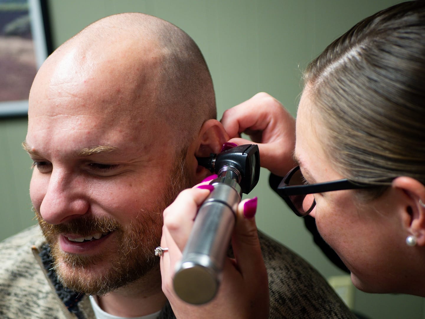 Someone getting their ears examined