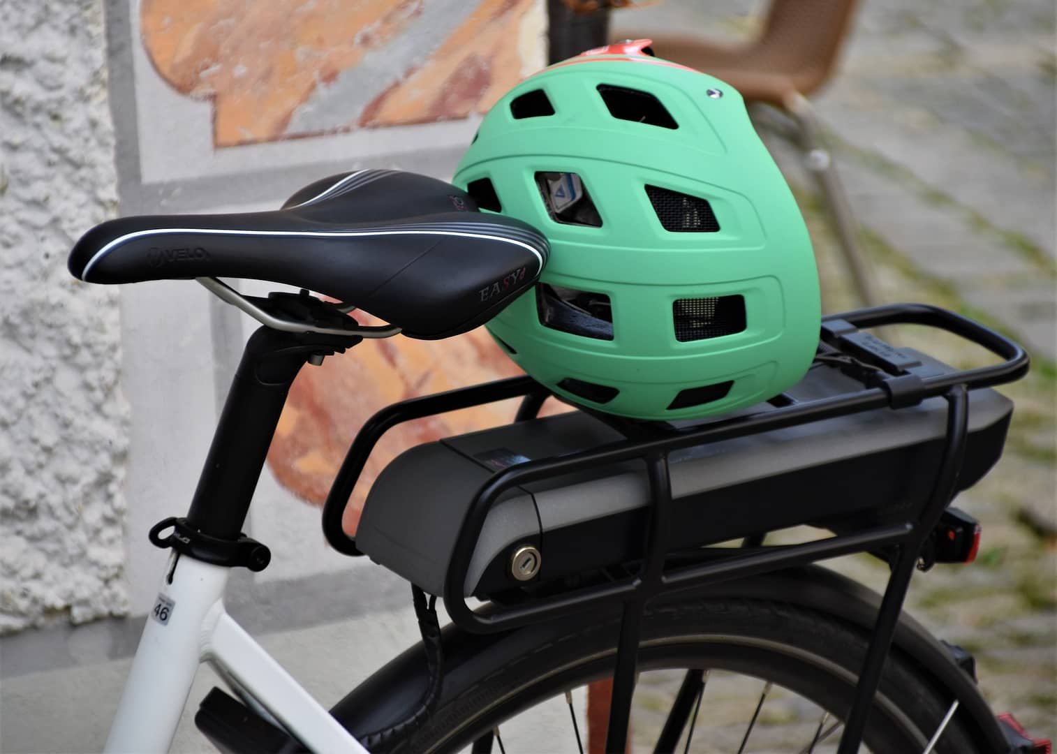 A cycling helmet on the back of a bike