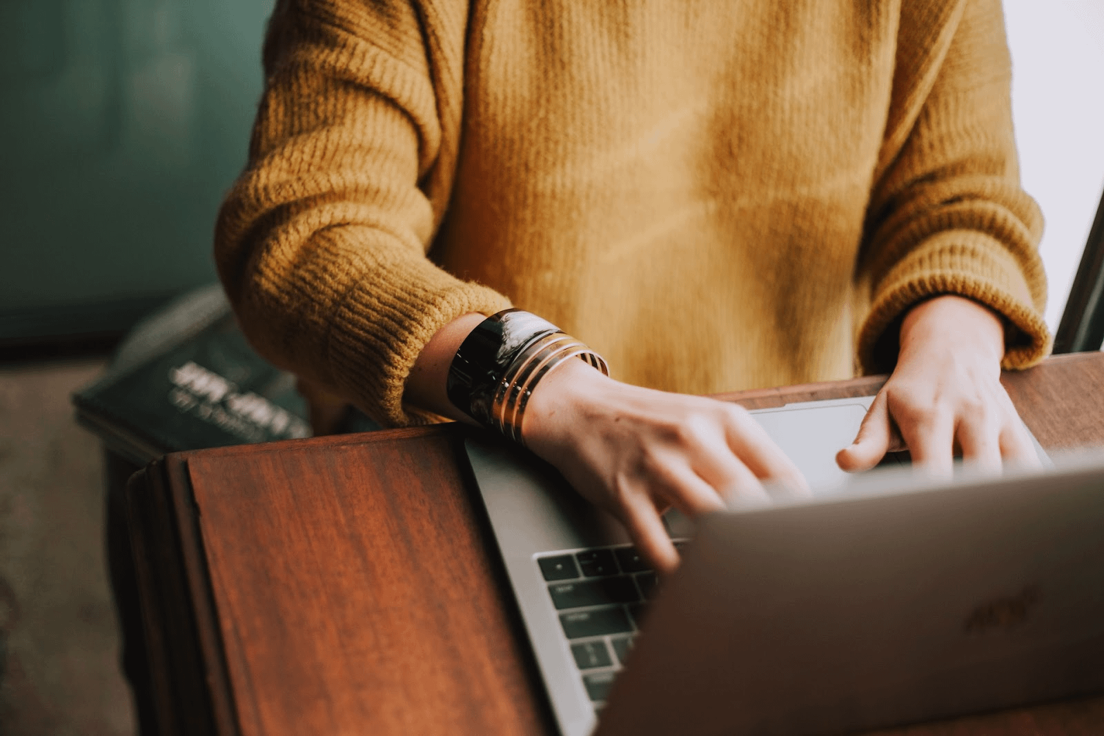 typing on a laptop at a desk