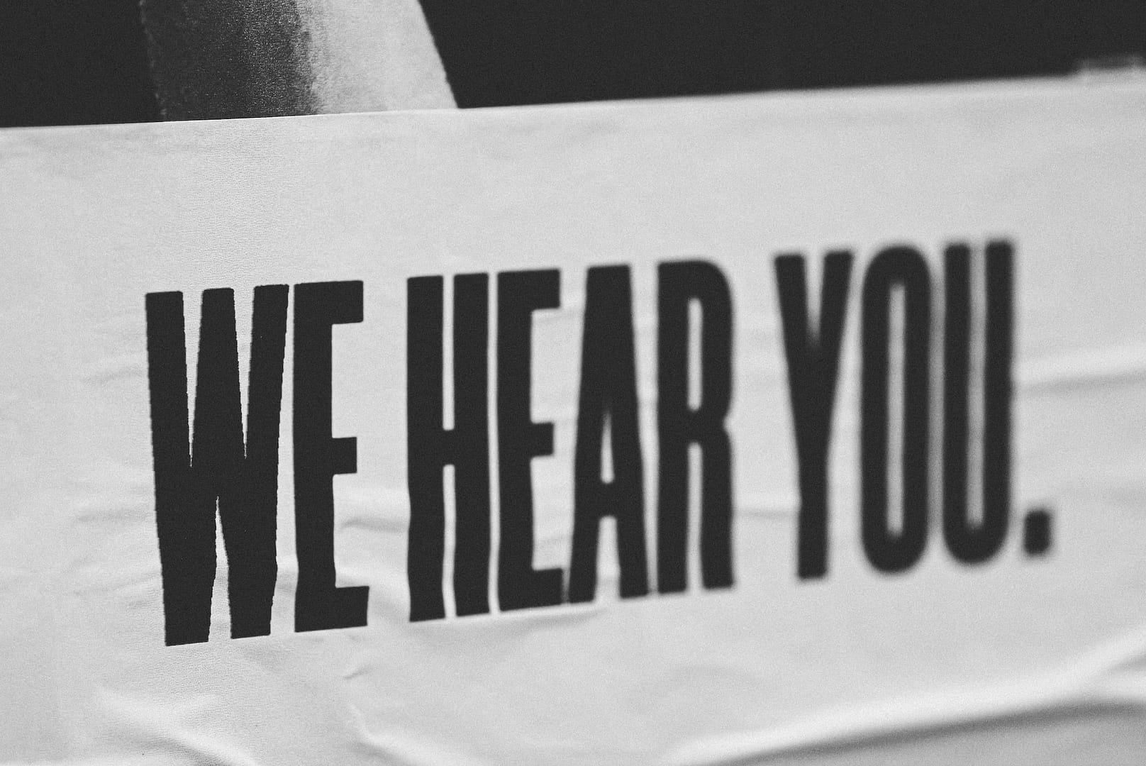 A 'we hear you.' sign