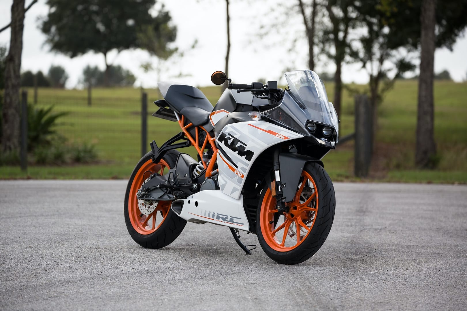 White, black and orange parked KTM motorbike