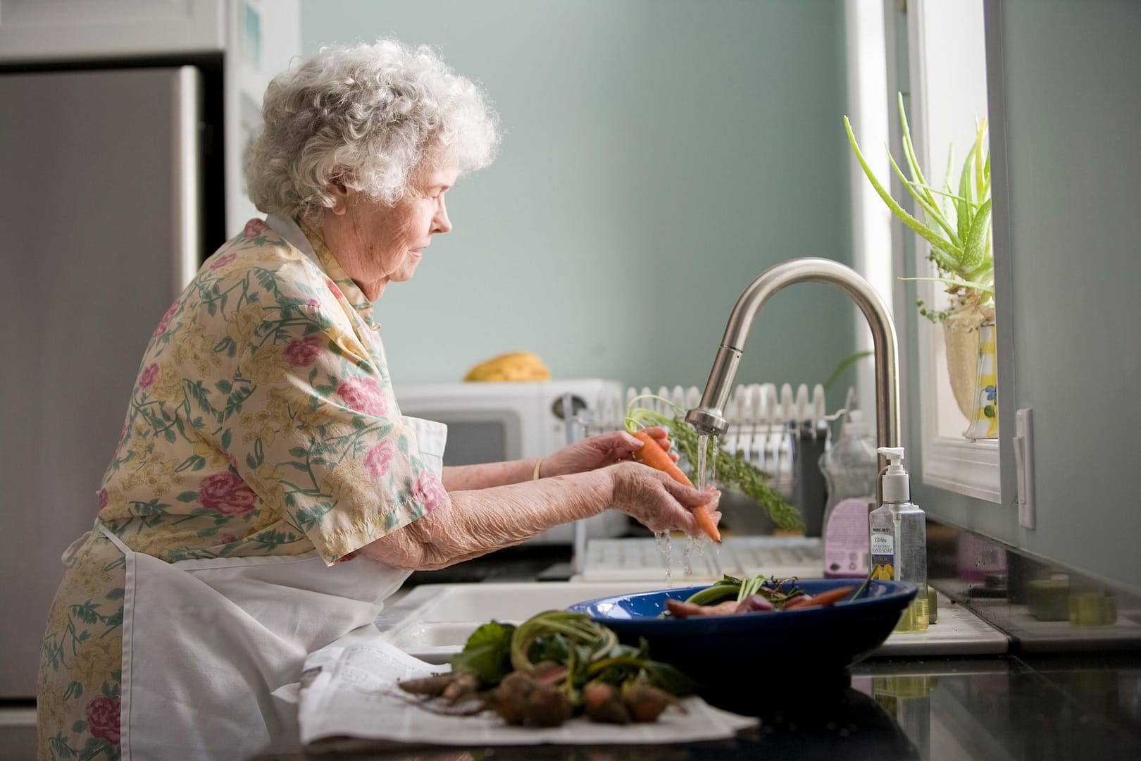 An elderly person in a kitchen