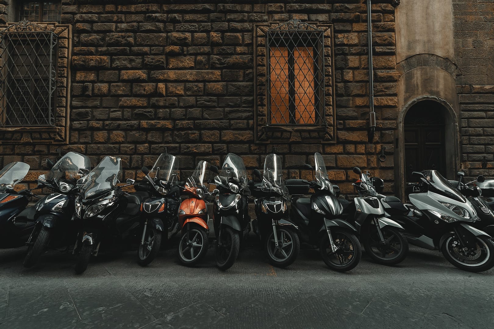 A row of parked vespas