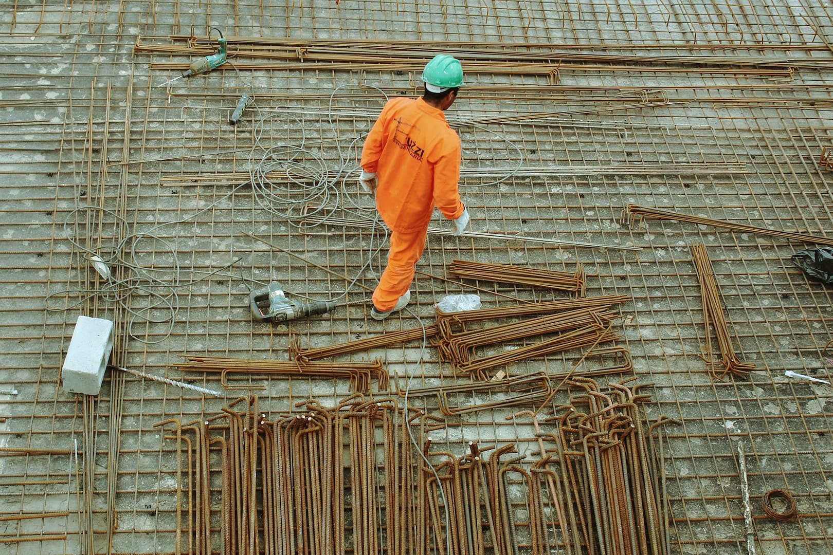 Protective clothing and a hard hat with someone working on a building site