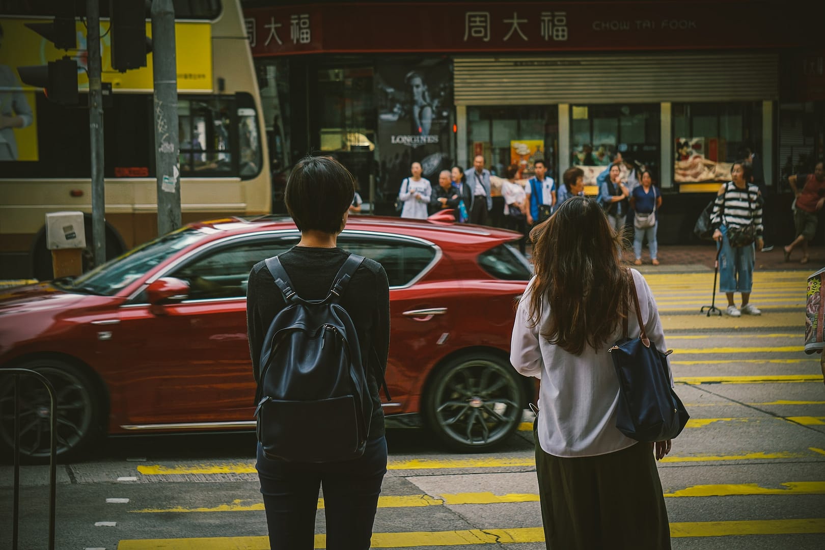 two people waiting to cross the road