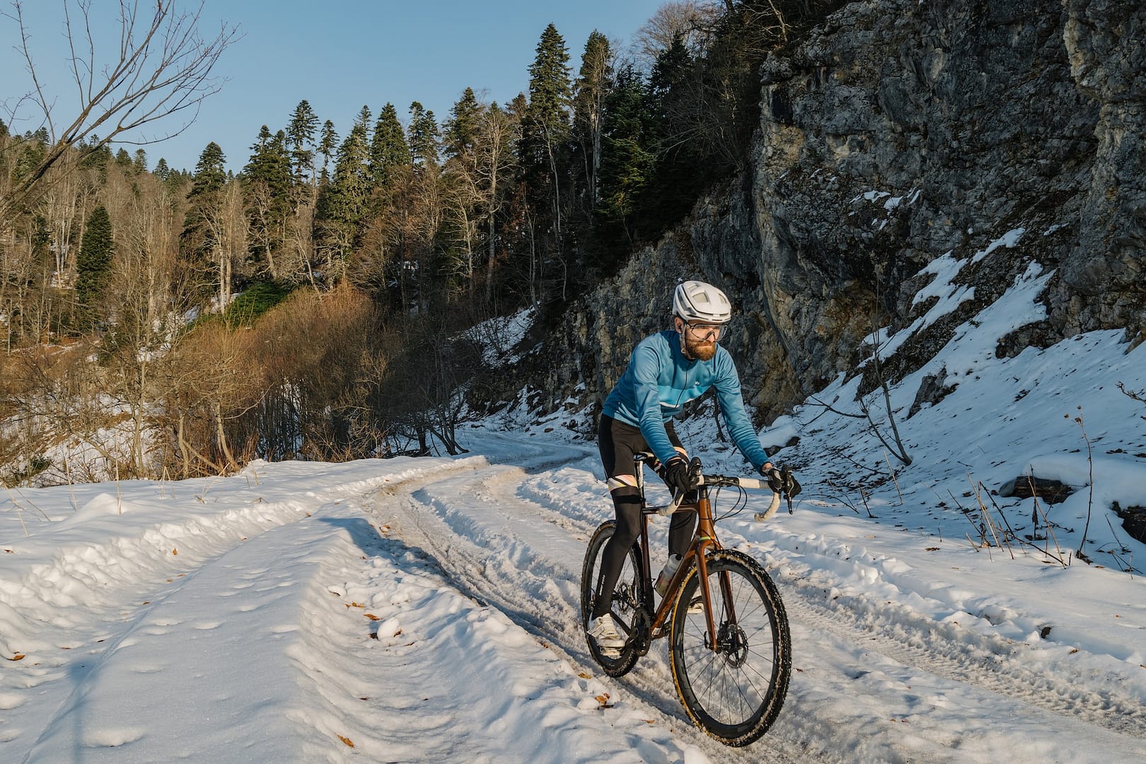someone cycling in snowy terrain