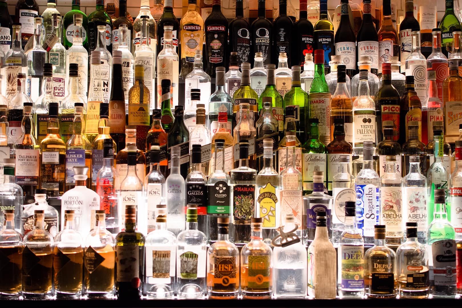 A bar well stocked with a collection of alcohol