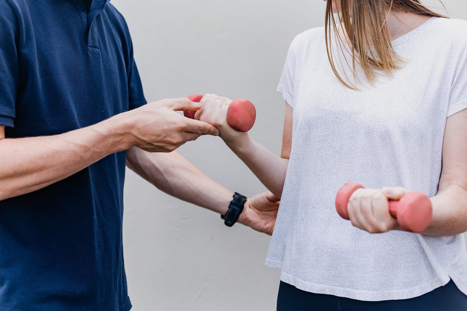 Someone building up the strength in their wrists with weights