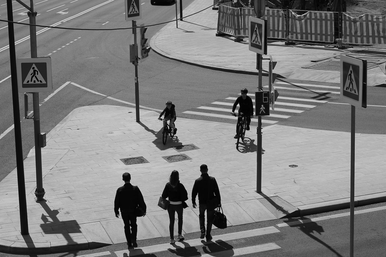cyclists and pedestrians crossing a road