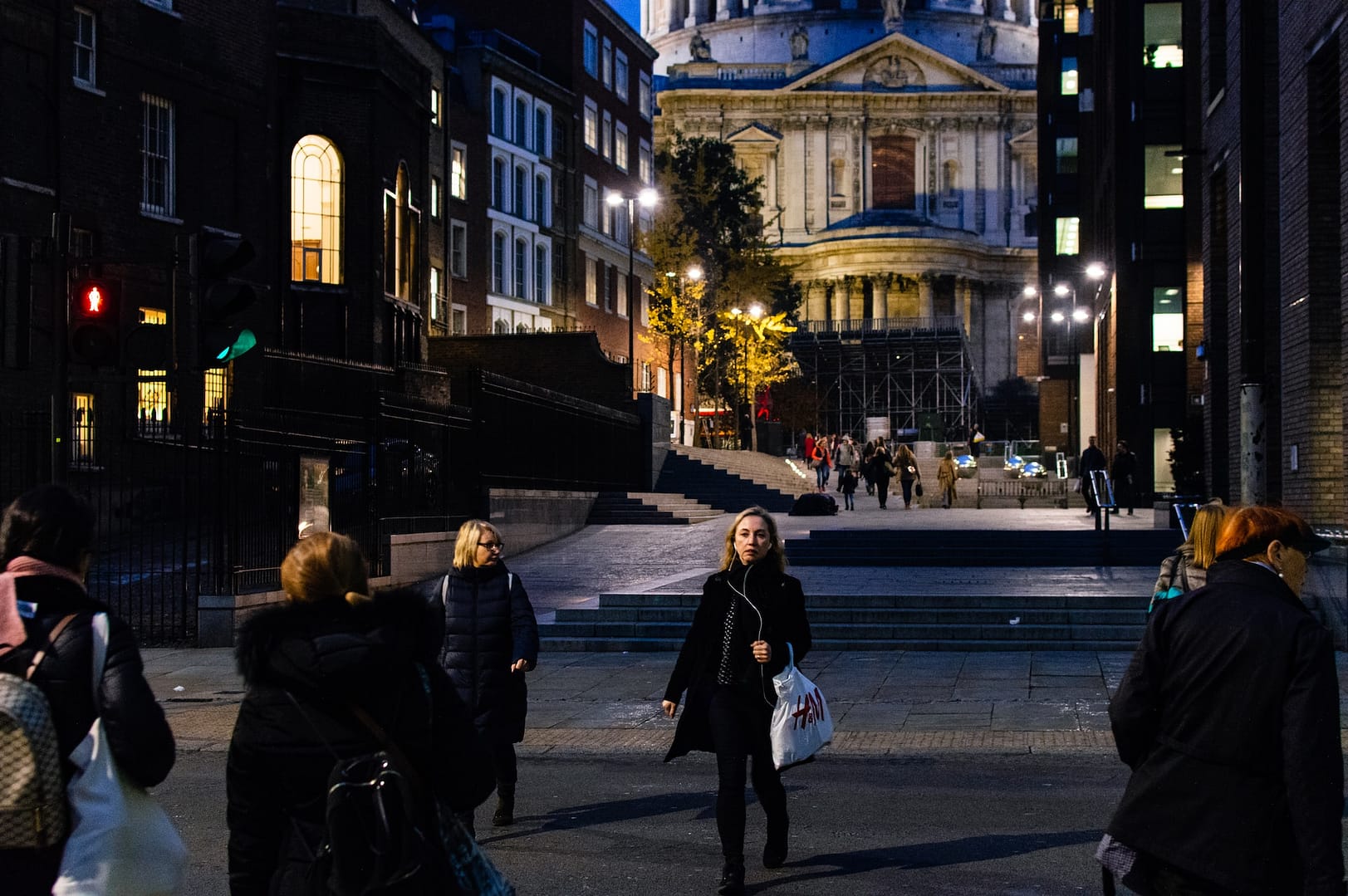 people walking in front of St Pauls Cathedral at night