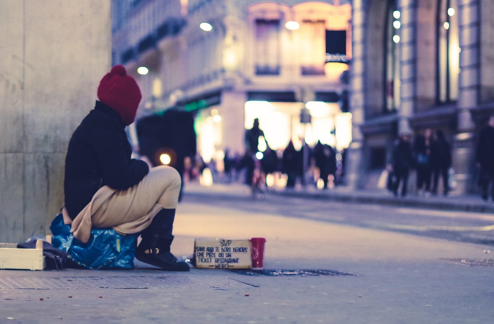 A homeless person on the corner of a street