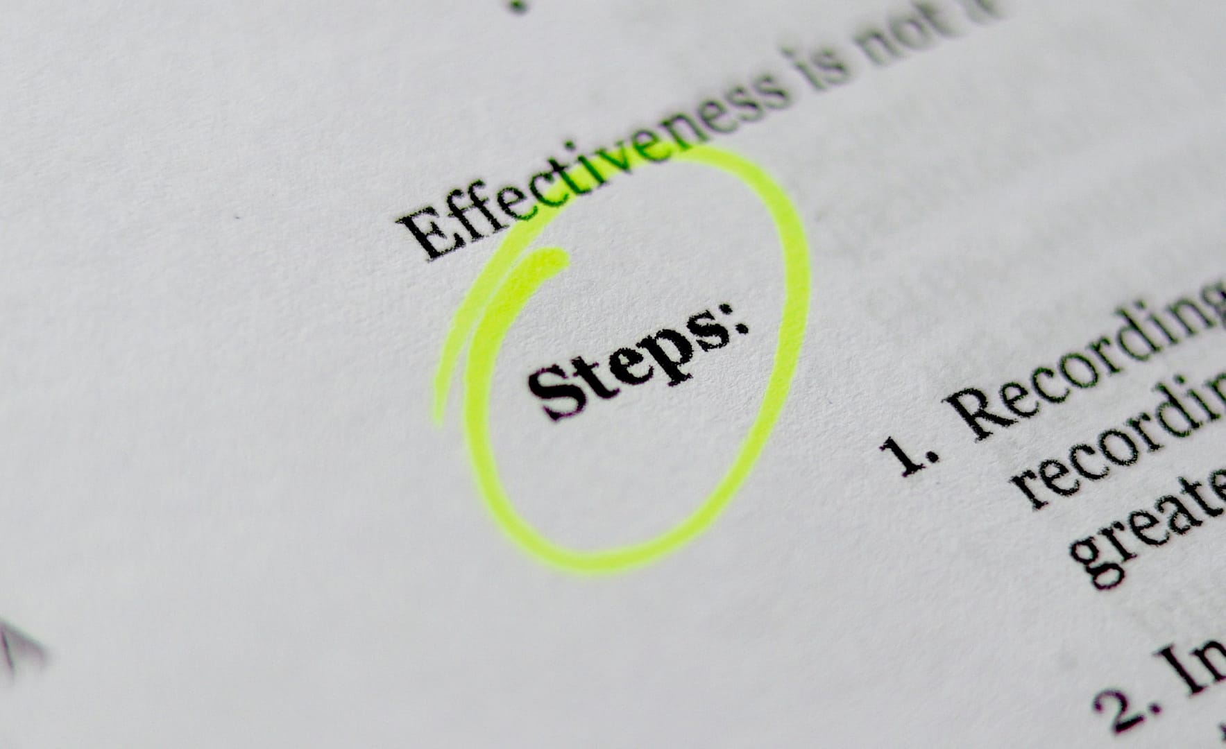 A paper highlighting the word 'steps' in yellow highlighter