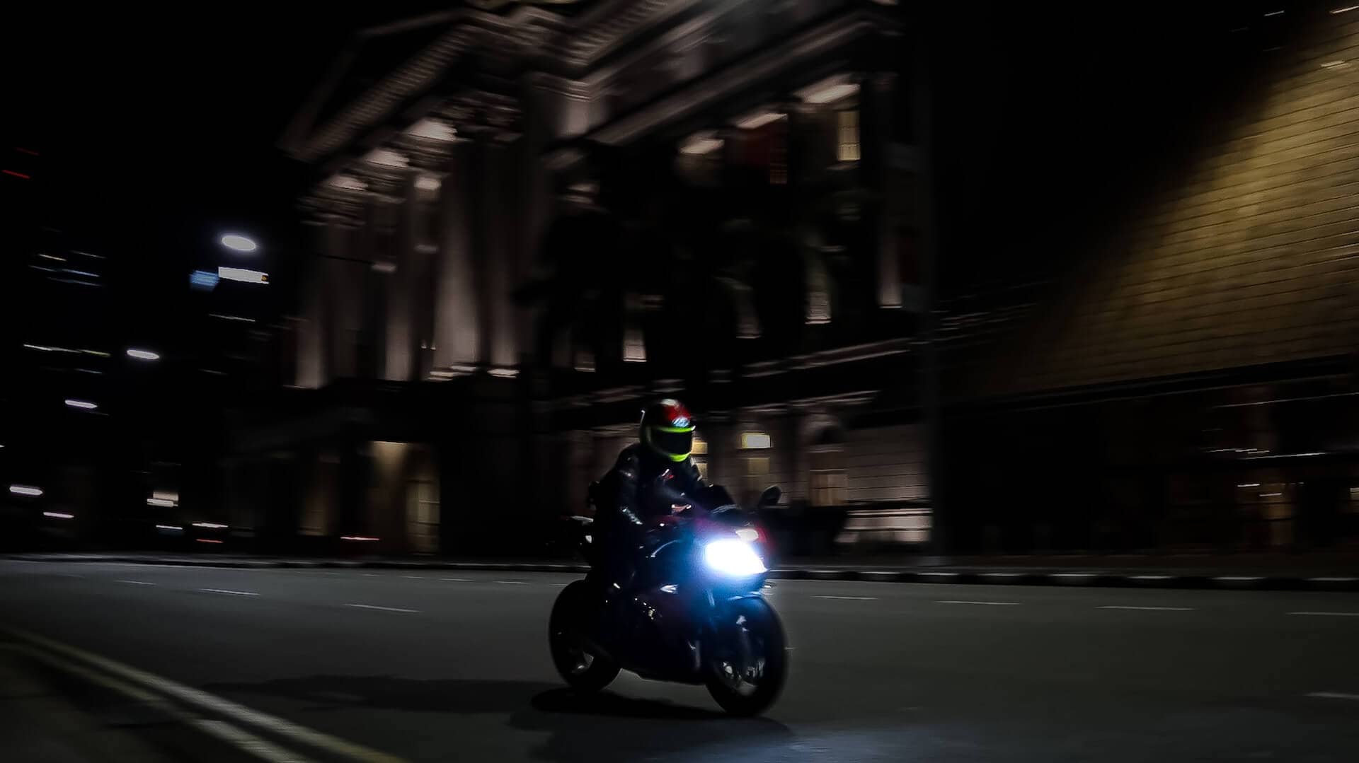 Someone riding a motorbike at night