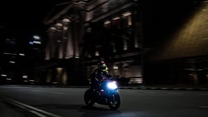 Someone riding a motorbike at night