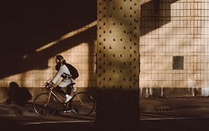 Someone cycling under a bridge