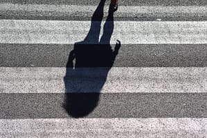 persons shadow at a pedestrian crossing