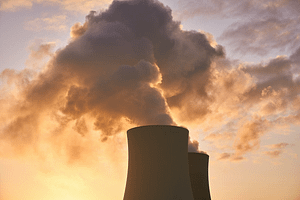 A powerplant building with smoke being released from the top