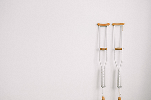 A pair of crutches resting against a wall