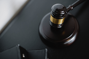 a gavel on a black desk