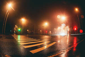 A pedestrian crossing lit up at night