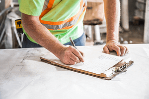 Person writing in a clipboard