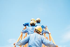 Four men in hardhats climbing stairs