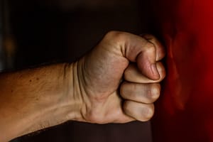 fist against a red wall