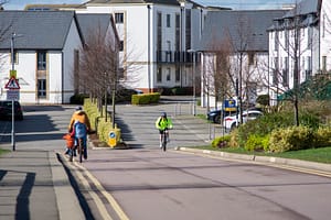 people riding their bikes on the street