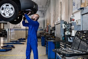 a mechanic working underneath a car