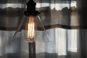 A lightbulb in a glass lampshade