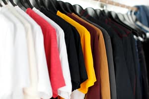 A clothing rack full of different coloured t shirts