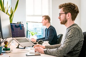 Two people sat at their desk