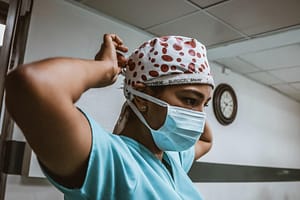 A doctor applying a mask