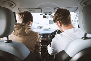 Two people at the front of a car