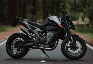 A black motorbike parked in the middle of a road