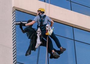 Someone cleaning windows of a skyscraper