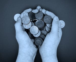 Someone holding a number of 2p coins in both hands