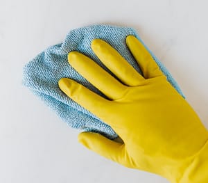 Someone with a rubber glove and cloth