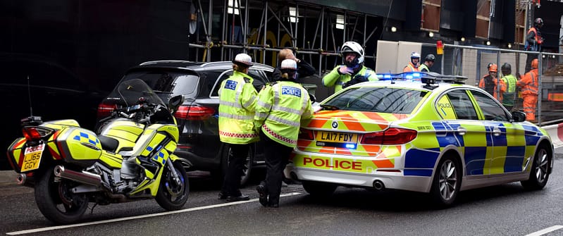 police crowding around a vehicle