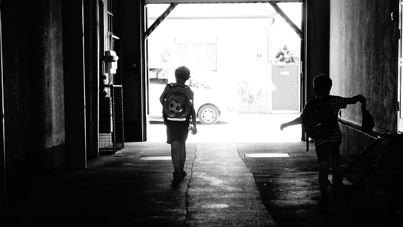 two school children walking